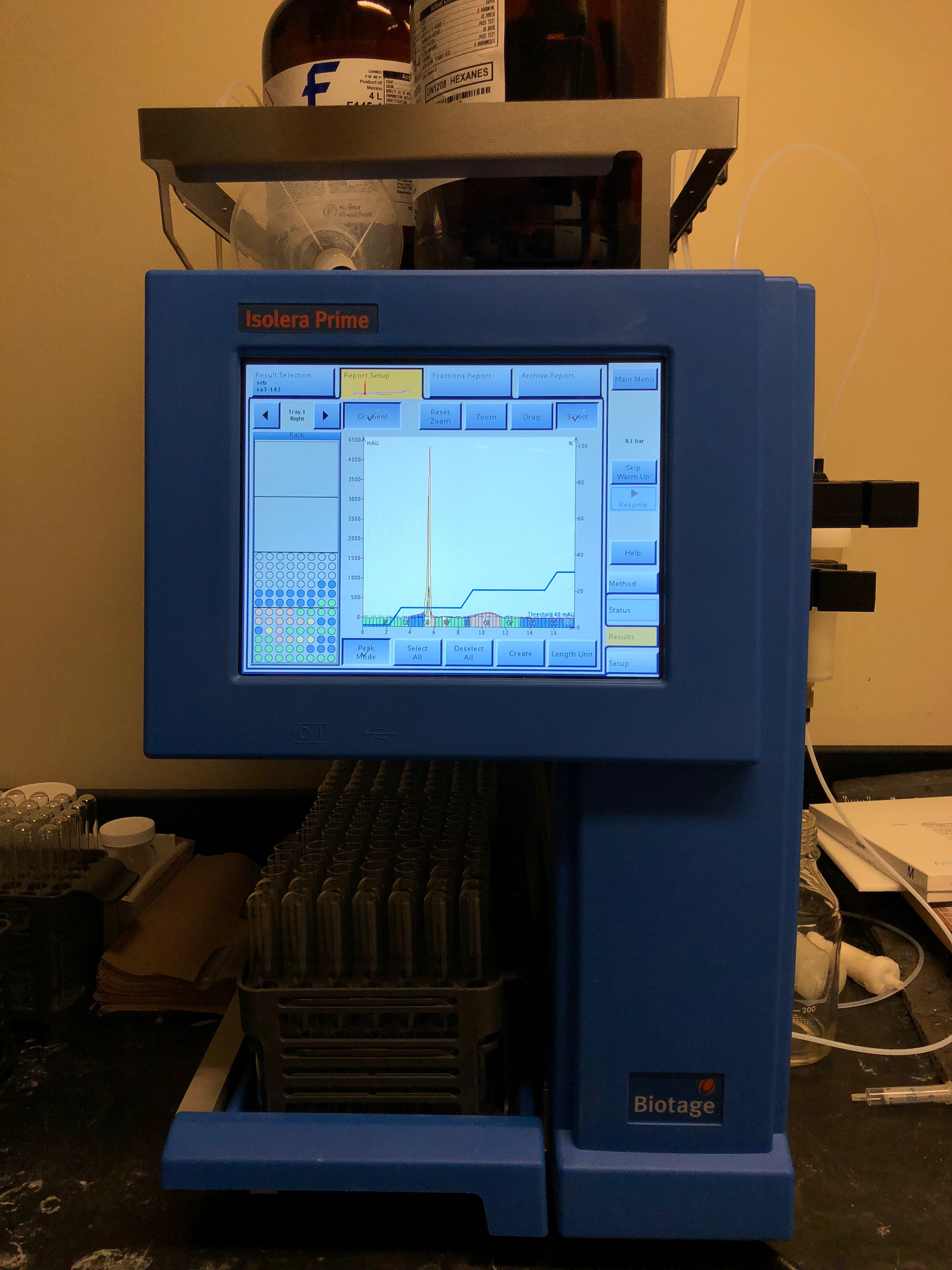 Biotage (auto column chromatography) machine sitting on a benchtop with a touchscreen and test tubes underneath