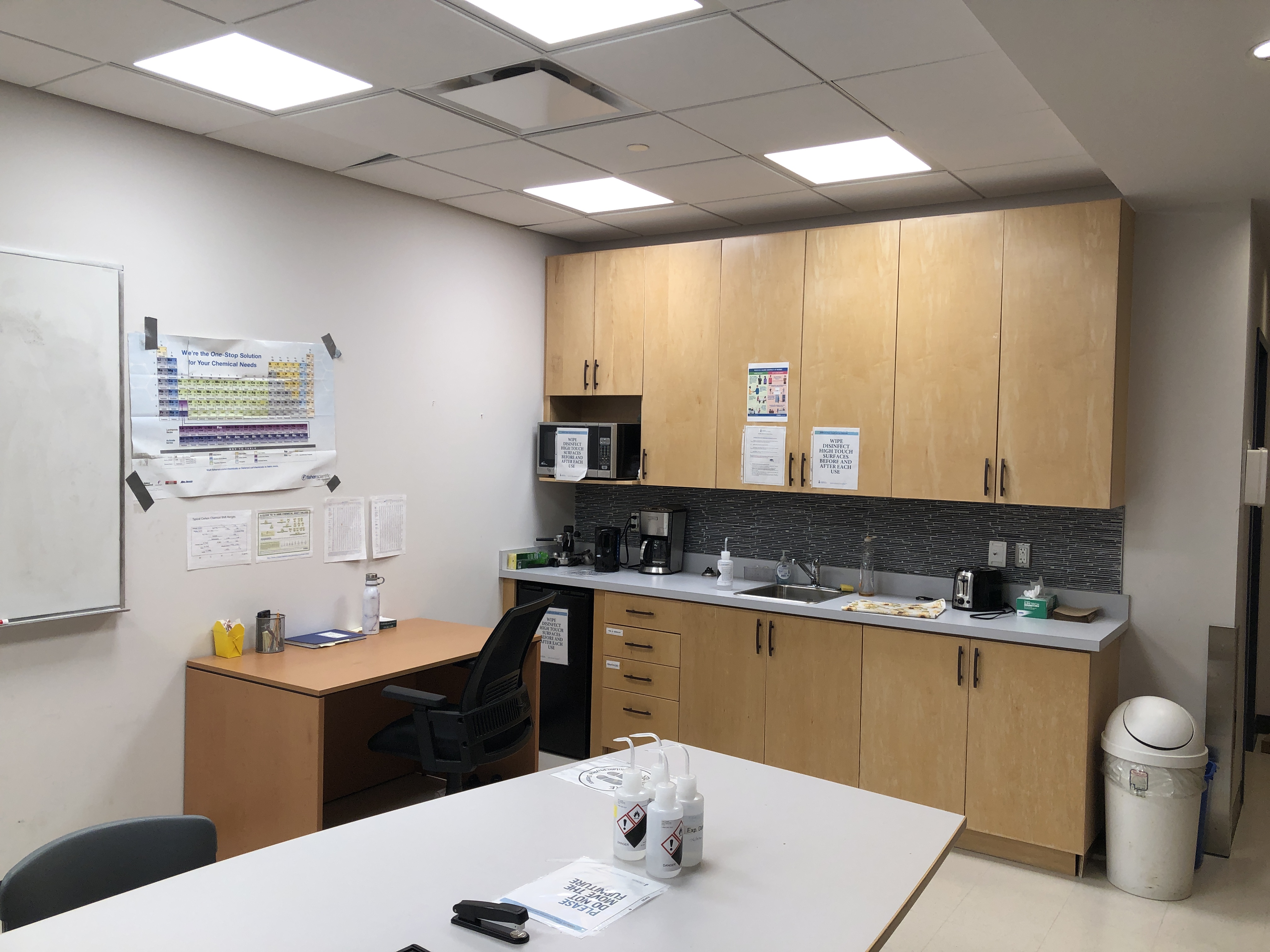 Photo of a kitchenette in the group with counter space, a sink, a microwave, cupboards, and a coffee maker