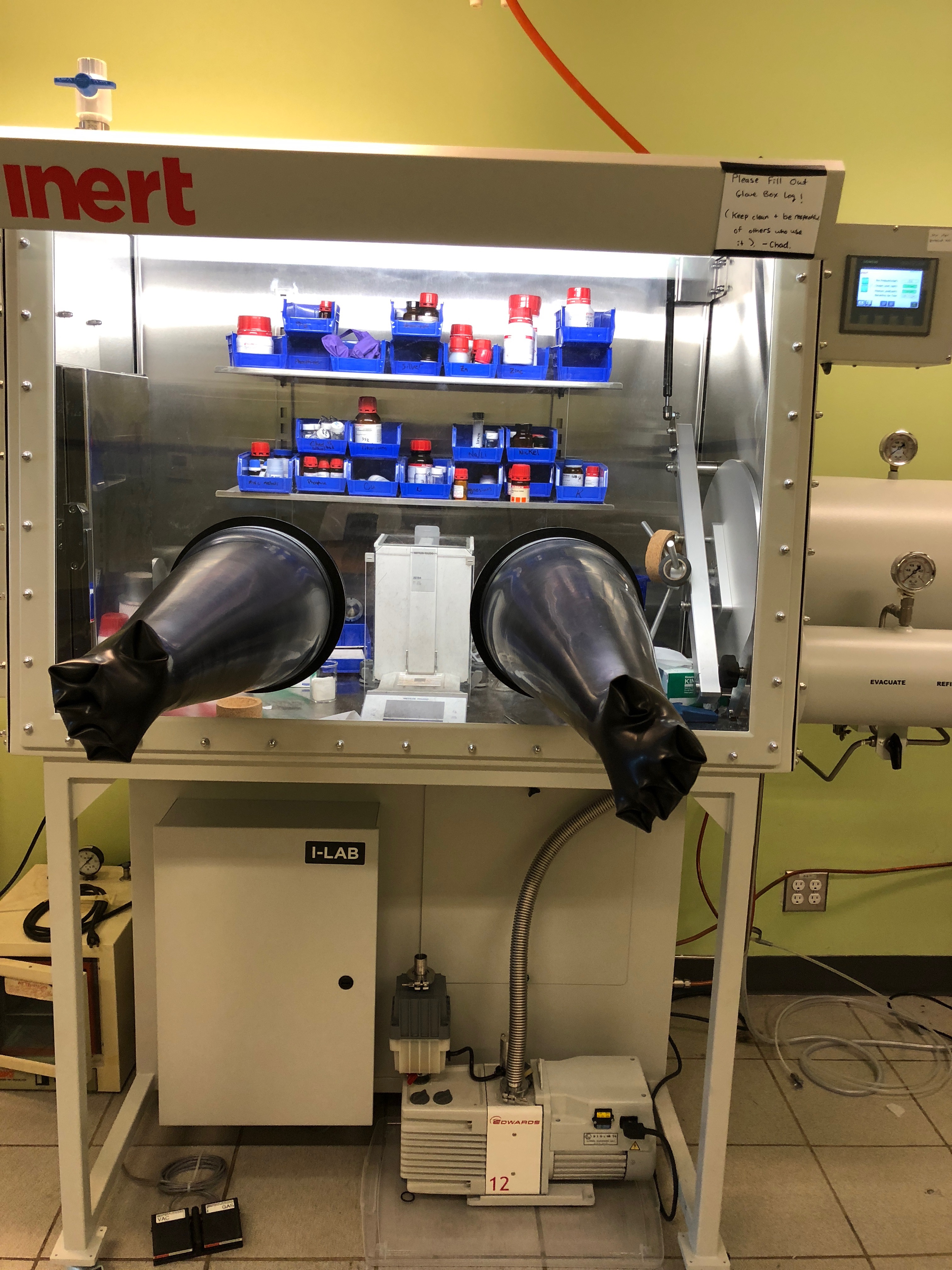 Small glovebox in the instrument room with one pair of gloves sticking out